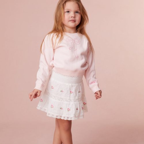 Girls skirt embroidered with small rosebuds all over, an elasticated waistband and lace details all over.