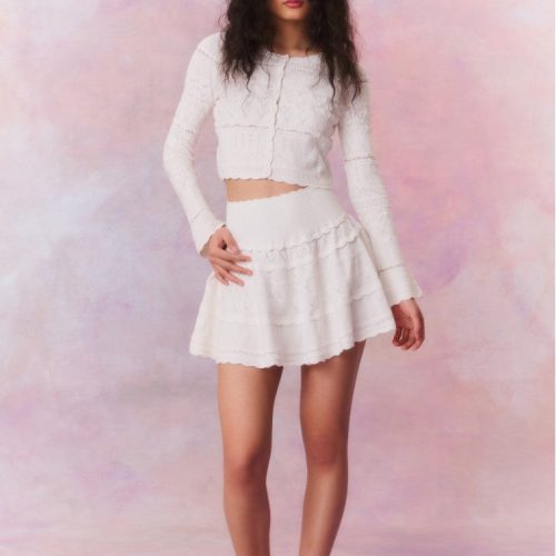 Knitted mini skirt featuring a ribbed yoke, elasticated waistband and a flouncy skirt.