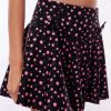 Black active skort with a pink floral pattern. Two patterned bows placed on each frontside of hip.