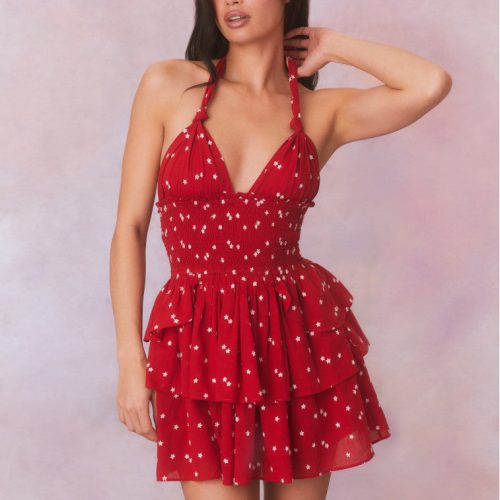 Red halter dress with a white star pattern, has a smocked bodice and a 3 tier skirt. 