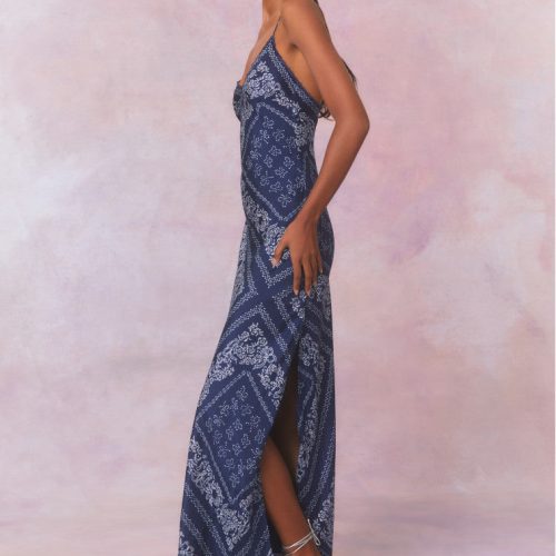 Slight form fitting blue bandana print silk habotai maxi dress with tiny spaghetti straps above a slight v-neckline, with a long skirt.