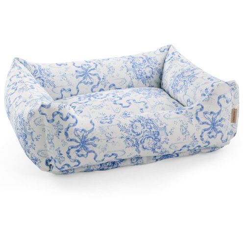 Dog bed with a bow and floral print.