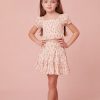 top features a dainty floral print, a smocked center front, short puff sleeves, and sweet ruffle detailing at the sleeve openings, neckline and the hem.