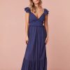 Maxi dress featuring short flutter sleeves with cascading ruffles and elastication for comfort, a v-neckline, a smocked bodice with ruffles, and a flouncy skirt.