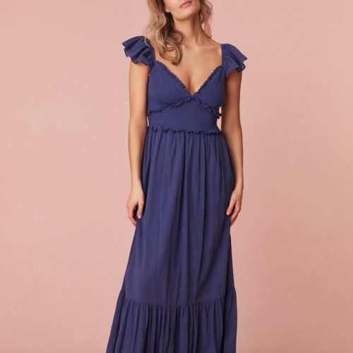 Maxi dress featuring short flutter sleeves with cascading ruffles and elastication for comfort, a v-neckline, a smocked bodice with ruffles, and a flouncy skirt.