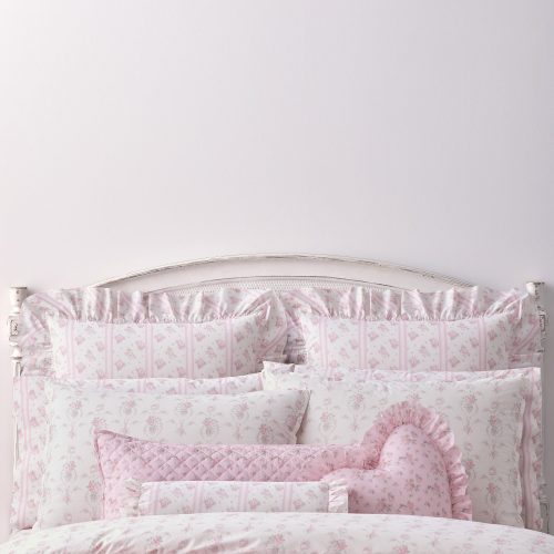 This dreamy ensemble features a delicate pink floral pattern on a pristine white backdrop. Crafted from 100% cotton