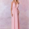 Pink floral halter maxi dress that ties in the back, flowing into an airy skirt.