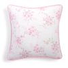 White throw pillow with a pink  floral print.