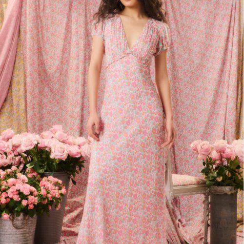 Two-toned floral printed maxi dress with short flutter sleeves, a deep v-neckline that descends to a tiny ruffle tier at the waistline before falling to a sweeping skirt.