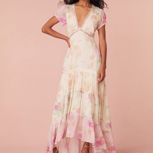 Maxi dress with a floral print mix in pink, cream, and light green. This dress begins with a v-neckline and a lace-trimmed waist seam, falling to a flowy skirt.