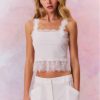 White cami top with lace trim along the bottom, the necklines, and the straps.